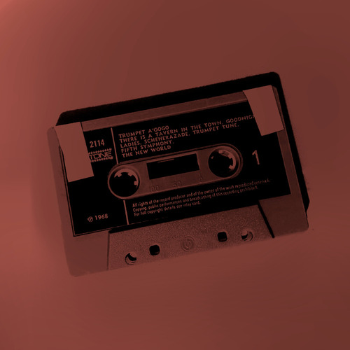 A deep red and black duotone image of a cassette tape, masking tape covering the holes that prevent recording over the tape.